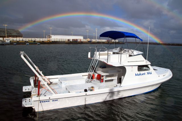 MARE Boat with a rainbow in the background